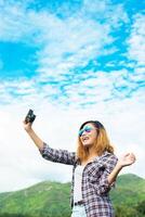 Young Hipster Woman with retro camera taking shot outdoor landscape ,Lifestyle mountain nature on background. photo