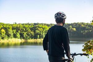 Athletes stand on the mountains and rivers with bicycle photo