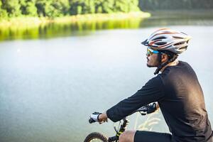 Athletes stand on the mountains and rivers with bicycle photo