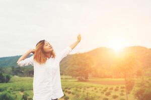 Beautiful women standing raising arm after waking, enjoy with fresh air in the morning. photo