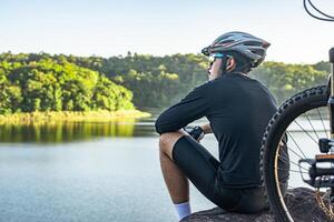 Athletes sitting on the mountain with bicycle photo