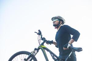 Mountain cyclists, walking to the top and bicycles photo