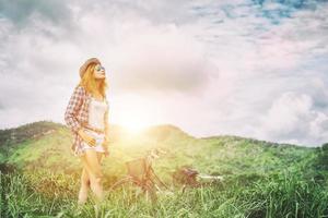 Young hipster woman enjoying fresh air in the mountain, freedom summer holiday, happy lifestyle. photo