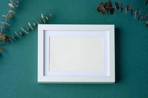 mock up frame on green table photo