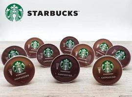 Bologna, Italy,2021, Starbucks capsule of Cappuccino isolated on wooden table photo