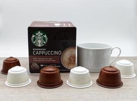 Bologna, Italy,2021, Starbucks capsule of Cappuccino isolated on wooden table photo