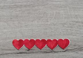 Red Valentines Hearts on wooden background. Place for text, copy space. Top view. Happy Valentine's Day concept. photo