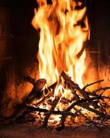 A fire burns in a fireplace photo