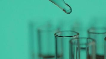 Close up of laboratory scientist working with a pipette analyzes and extract the DNA or molecules in the test tubes.on blur background with virtual interface video