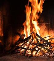 A fire burns in a fireplace photo
