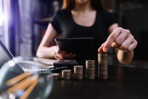 Business accountant working on desk using mobile phone and calculator to calculate budget concept finance and accounting photo