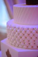 Wedding cake with luxury decorated in wedding party. Cake decorated with crown photo