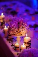 Beautiful, decorated table with flower decorations and red candles. Christmas evening or wedding party decoration. photo