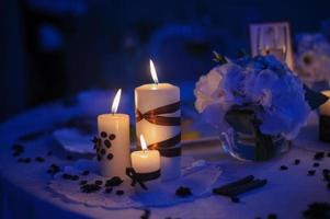 Beautiful, decorated table with flower decorations and red candles. Christmas evening or wedding party decoration. photo