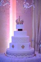 Wedding cake with luxury decorated in wedding party. Cake decorated with crown photo