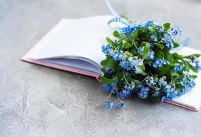 Forget me not flowers and notebook photo