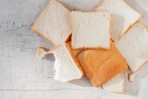 Bread slides on white wooden background photo