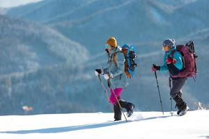 Two people in the mountains in winter photo