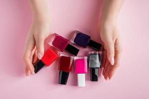 Female hands with bright nail polishes.