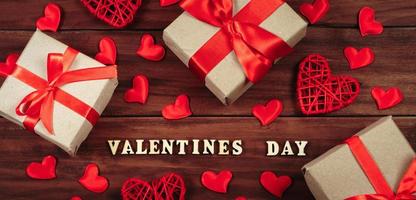 Valentine's day concept. Gifts in craft paper with red ribbon. photo