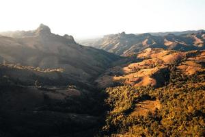 mountains and orange grass in the evening photo