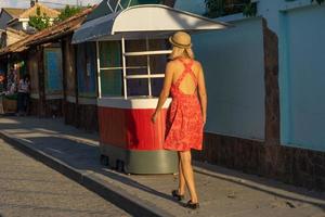 evpatoria, crimea-25 de mayo de 2018-paisaje urbano de las calles de la ciudad con una chica con un vestido rojo foto