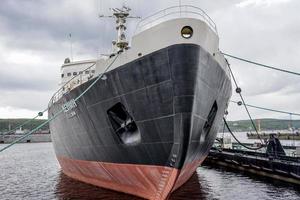 Murmansk, Russia-June 5, 2015 -Cityscape with icebreaker Lenin at the pier of the sea station. photo