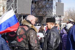 Sevastopol, Crimea-March 16, 2015- portrait of two men talking in a crowd. photo