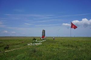 Feodosia, Crimea-may 26, 2016 - Monument in the middle of the steppe with green grass against the blue sky. photo