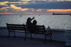 Sevastopol, Crimea-June 14, 2014 - Girl watching the sunset over the sea in the Sevastopol Bay photo