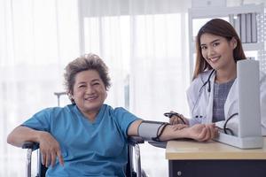 Female Doctor Consoling Senior Patient In Hospital photo