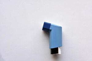 Asthma inhaler spray on a white background photo