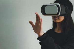 girl wearing reality glasses, vr box. Focus hand. photo