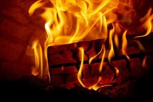 Burning log of wood in a fireplace close-up. photo