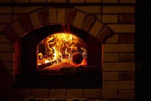 Burning log of wood in a fireplace close-up. photo