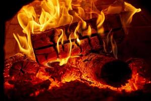 Burning log of wood in a fireplace close-up. photo