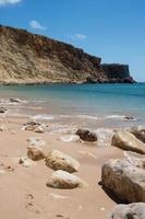 Rocks on an empty beach with no people, sunny day. Sagres, Algarve, Portugal photo