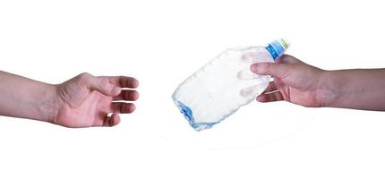 A man passes an empty, plastic bottle, isolated on a white background. photo