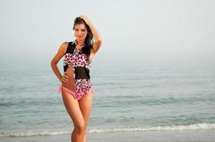 Woman with beautiful body on a tropical beach photo