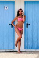 Woman with beautiful body in a beach hut photo