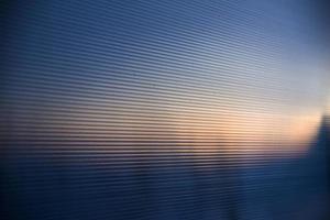 Striped blue polycarbonate in the rays of the evening sun photo