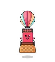 matches box mascot riding a hot air balloon vector