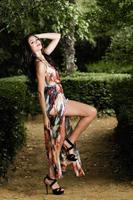 Beautiful young woman, model of fashion, in a garden photo
