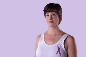 Woman with pink ribbon fighting against cancer. photo