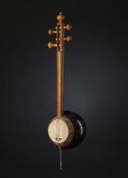 ancient Asian stringed musical instrument on black background with backlight photo