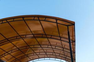 plastic carport. brown transparent roof made of polycarbonate with metal structures photo