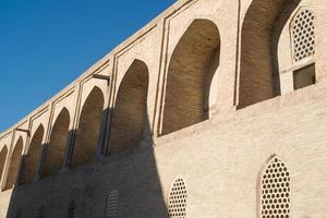 The old building, the wall with arches. Ancient buildings of medieval Asia. Bukhara, Uzbekistan photo