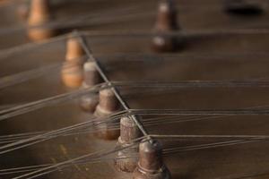 ancient Asian stringed musical instrument on black background with backlight. the similarity of the harp and psaltery. closeup photo