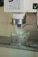 closeup lathe machine and coolant during processing photo