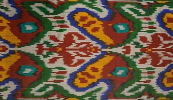 Background from the tissue with oriental ornaments and multi colored pattern, textile photo